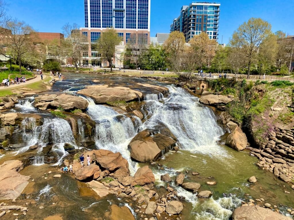 a waterfall in the middle of a city park