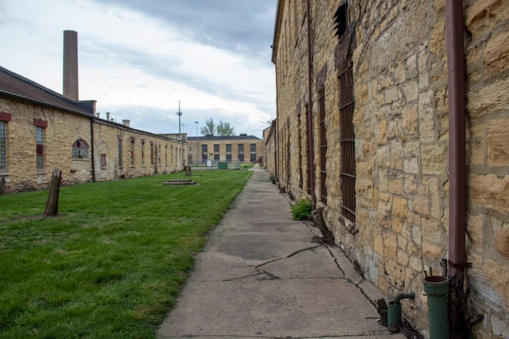 a stone building with a green lawn in front of it