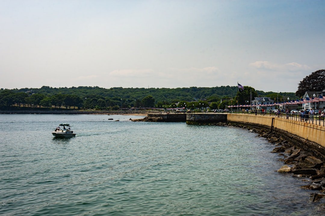 A boat is in the water near a pier