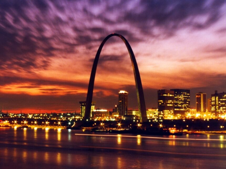 Gateway arch and city skyline at sunset